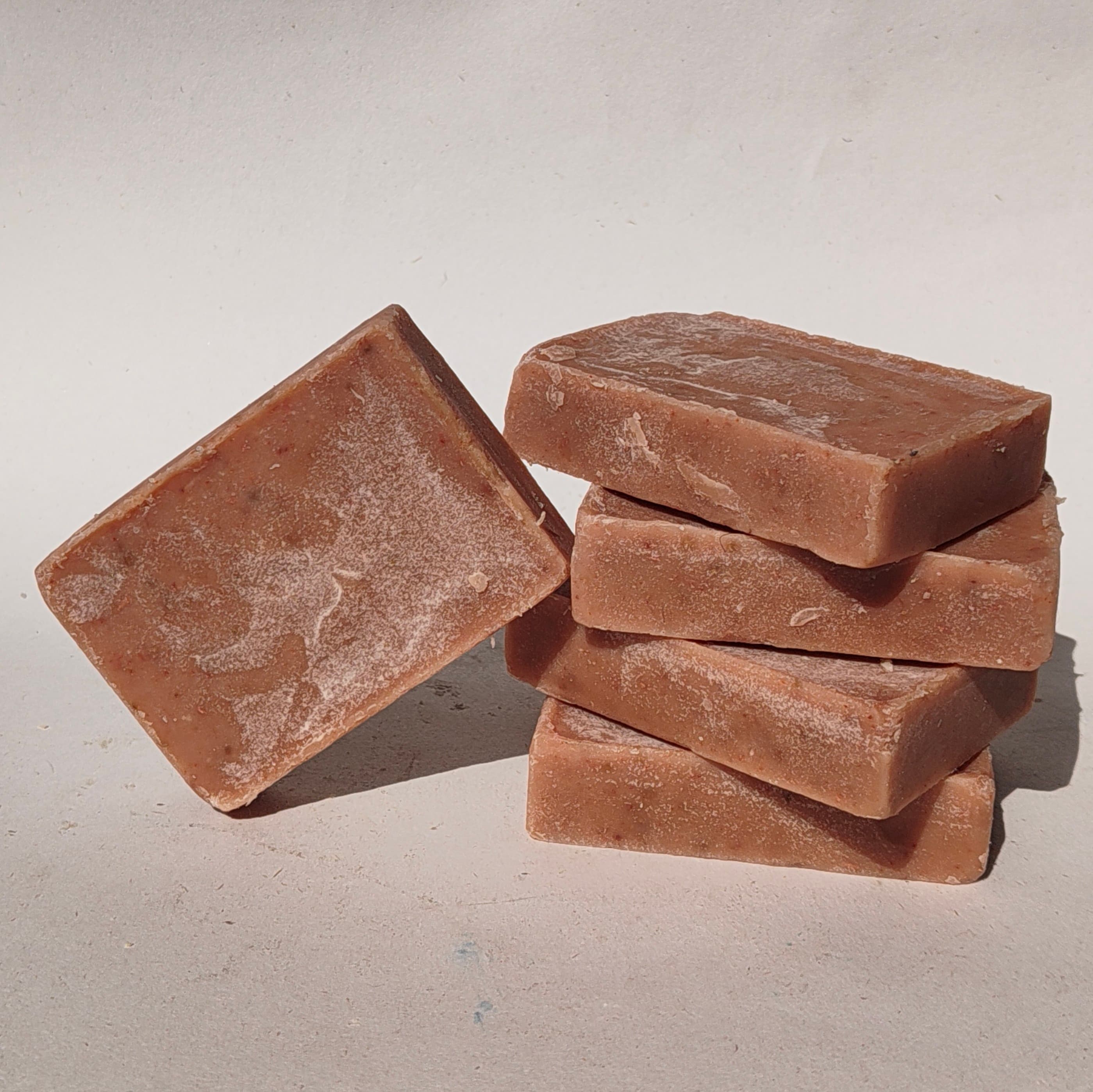Hand-cut soap bars curing on a wooden rack